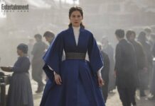 Rosamund Pike como Moiraine em A Roda do Tempo